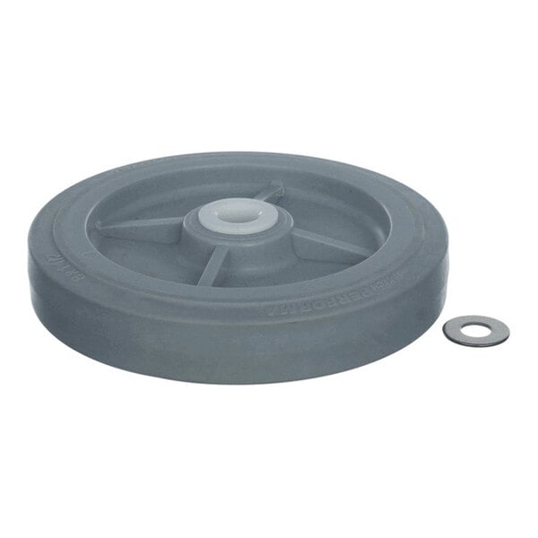 A gray wheel with a central hub and a separate metal washer placed beside it.
