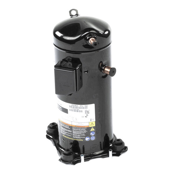 A black cylindrical metal component with two copper pipe fittings, a black electrical box, and a label with technical information, mounted on a base with four feet.