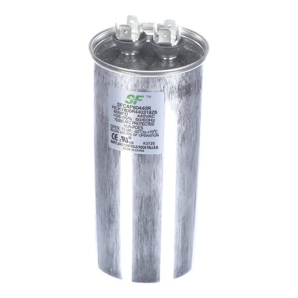 A cylindrical metallic capacitor with two electrical terminals on top and a label with technical specifications on the side.