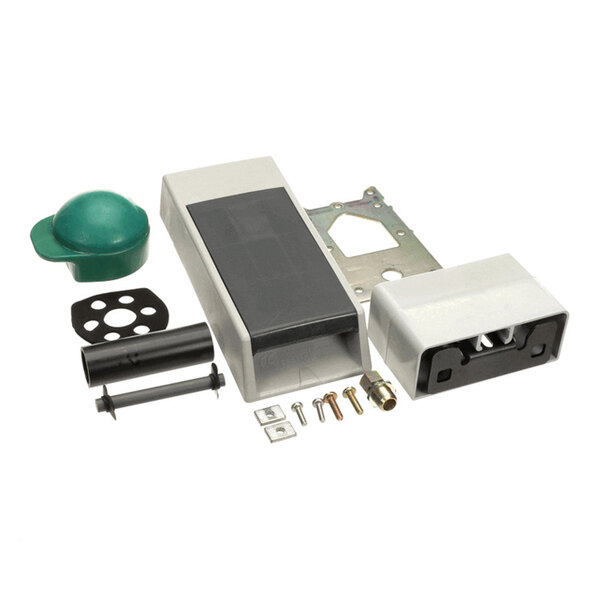 A set of various mechanical and plastic components, including a rectangular housing, screws, a green cap, a metal bracket, and other small parts, arranged on a white background.