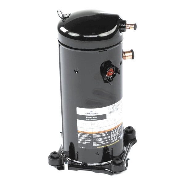 A black cylindrical metal component with copper pipe fittings and a label, mounted on a base with four feet.