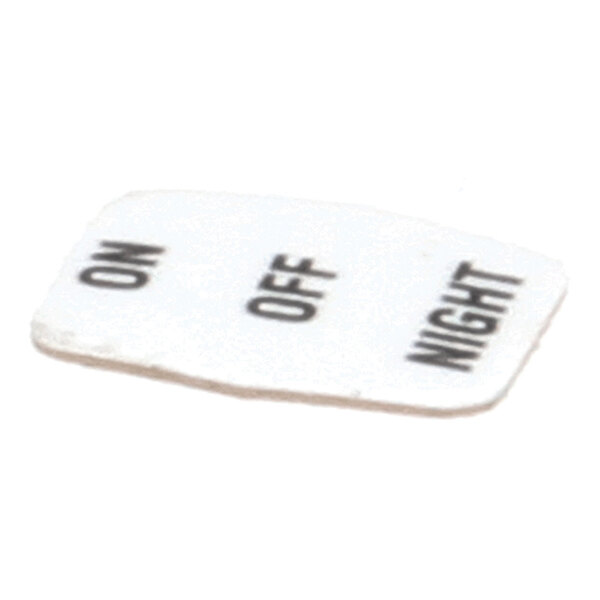 A small white decal with the words 'ON', 'OFF', and 'NIGHT' printed in black text.