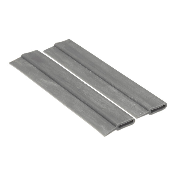 Two flat, gray, rectangular plastic pieces with a hollow section along one edge, placed side by side on a white background.