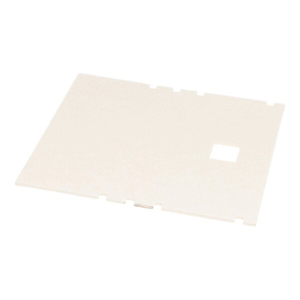 A flat, rectangular, off-white pad with a small square cutout and notched edges, lying on a white surface.