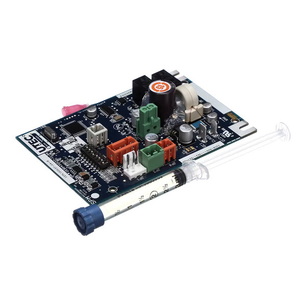 A circuit board with various electronic components and connectors, accompanied by a clear cylindrical tube with measurement markings and a blue cap.