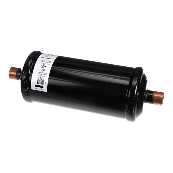 A cylindrical black metal component with copper fittings on both ends and a white label attached to the side.