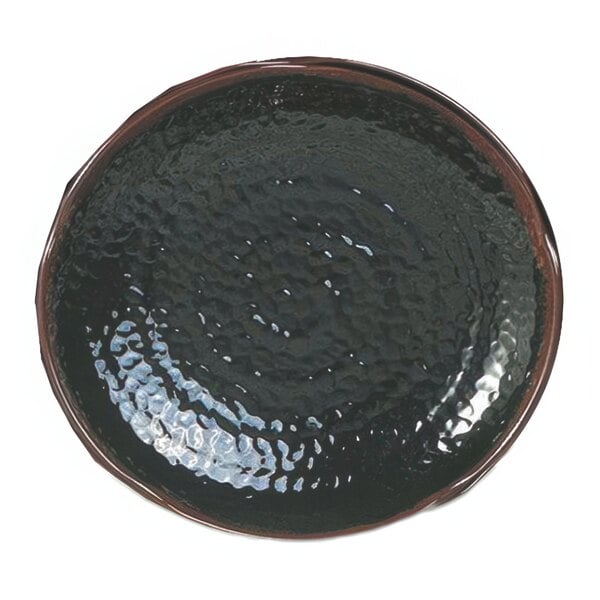 A close-up of a Thunder Group lotus shaped melamine plate with a textured black surface and a brown rim.