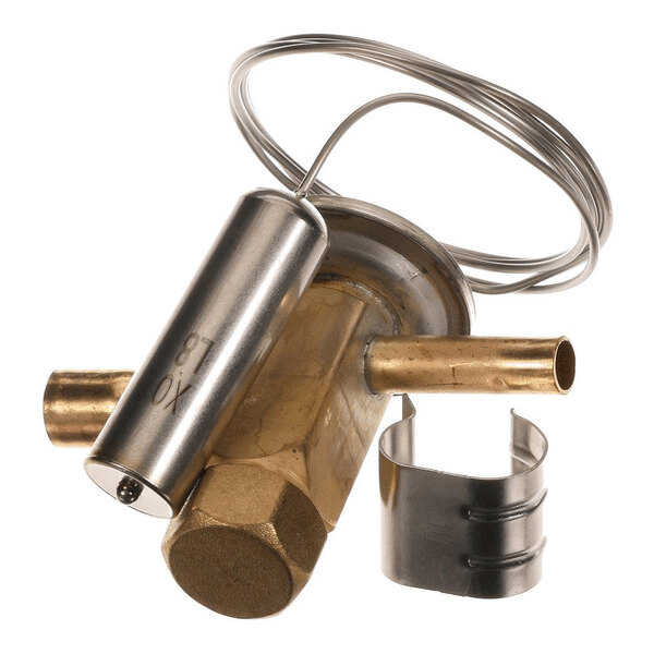 A brass and metal mechanical component with a cylindrical sensor, coiled tubing, and a separate metal clip, likely part of a refrigeration or HVAC system.