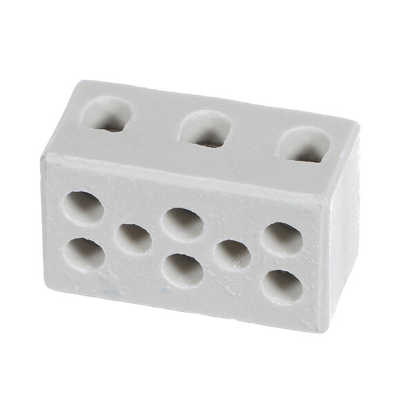 A rectangular white block with multiple round holes on its top and side surfaces.