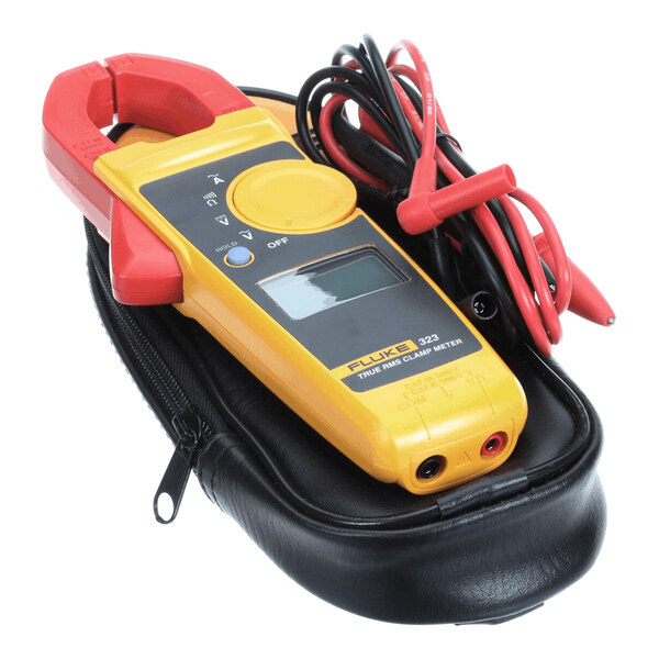A yellow and red digital clamp meter with attached test leads, resting on a black zippered carrying case.