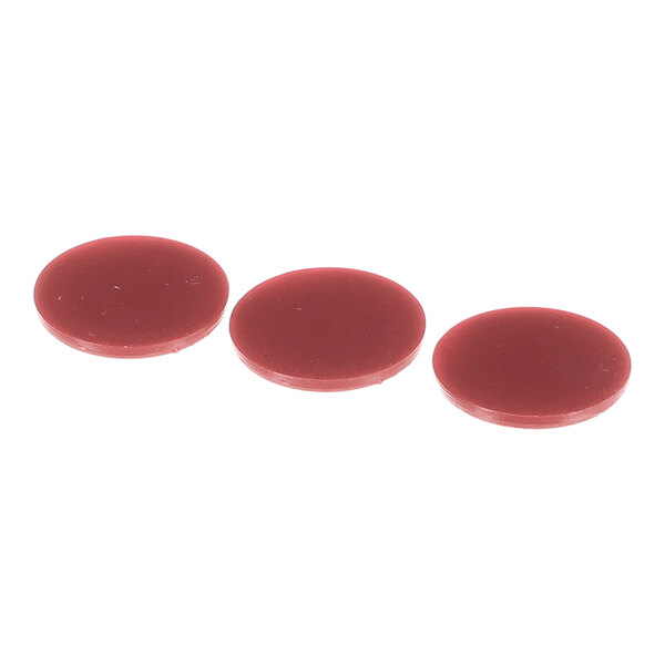 Three round, flat, reddish-brown discs are arranged in a row on a white background.