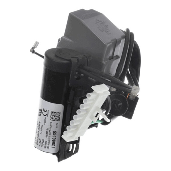 A small electronic component with a cylindrical black body, attached wires, a white connector, and a gray plastic housing.