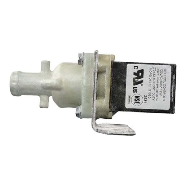 A small mechanical component with a white plastic body, metal mounting bracket, and a black rectangular section with a label containing technical information.