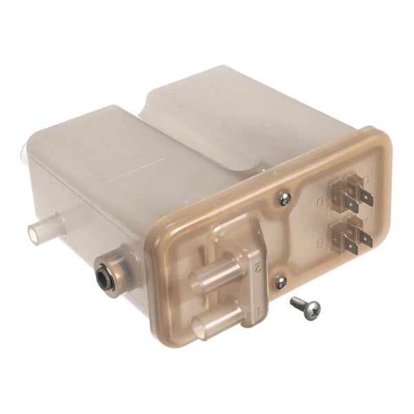 A translucent plastic reservoir component with multiple hose connectors, electrical terminals, and a loose screw placed beside it.