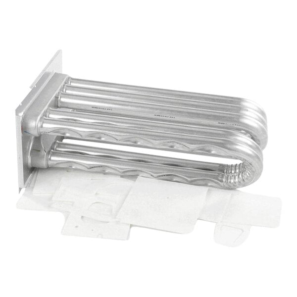 A metallic, tubular component with multiple parallel pipes bent in a U-shape, attached to a mounting plate, and some flat white gasket pieces placed underneath.