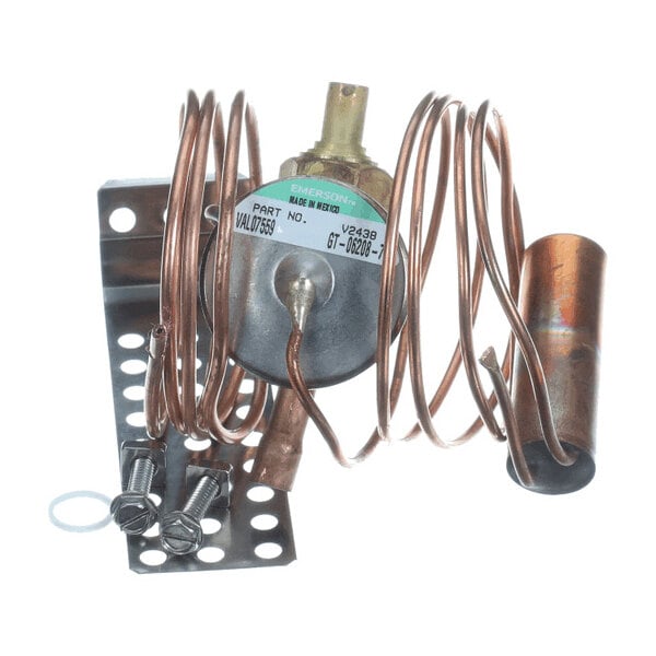 A metal valve assembly with coiled copper tubing, a cylindrical component, and mounting hardware including screws and a perforated metal bracket.