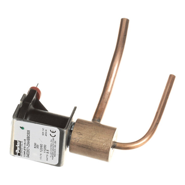 A metal valve assembly with two curved copper tubes and an attached black and silver solenoid component with a label.