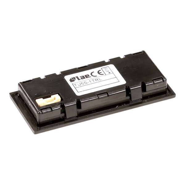 A rectangular black electronic component with a label and a small connector, likely a display module.