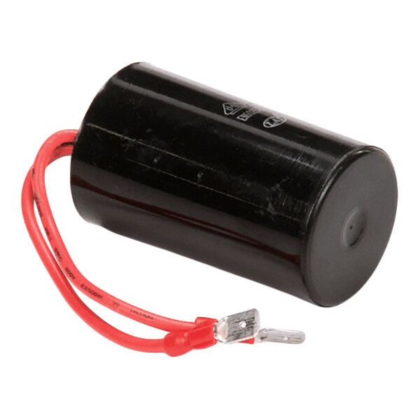 A cylindrical black component with a red wire attached, likely an electronic capacitor.