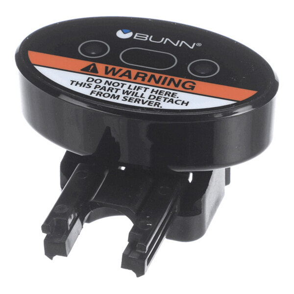 A black oval-shaped electronic component with a warning label, two buttons, and mounting prongs, labeled with the BUNN logo.