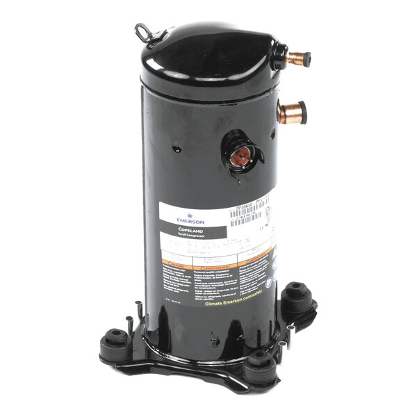 A black cylindrical mechanical component with copper pipe fittings and a label, mounted on a metal base.