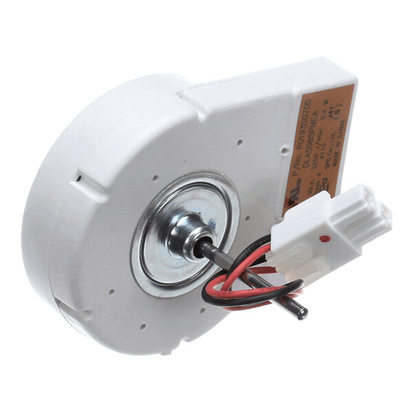 A white, circular electric motor with a central metal shaft, attached wires, and a plastic connector.
