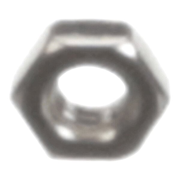 A blurry image of a metallic hexagonal nut with a central hole.