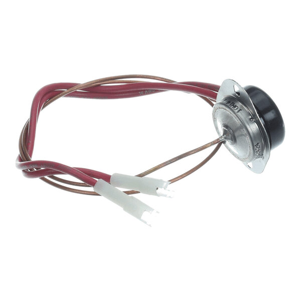 A round metallic component with two attached red wires and white connectors, likely an electrical or thermal device.