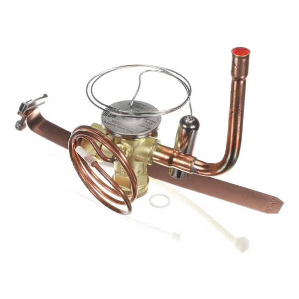 A metallic assembly featuring copper tubing, a brass valve, a coiled tube, and a few plastic accessories, likely part of a mechanical or HVAC system.