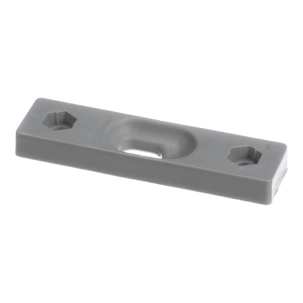 A rectangular gray plastic or metal plate with two hexagonal holes and a central recessed area.