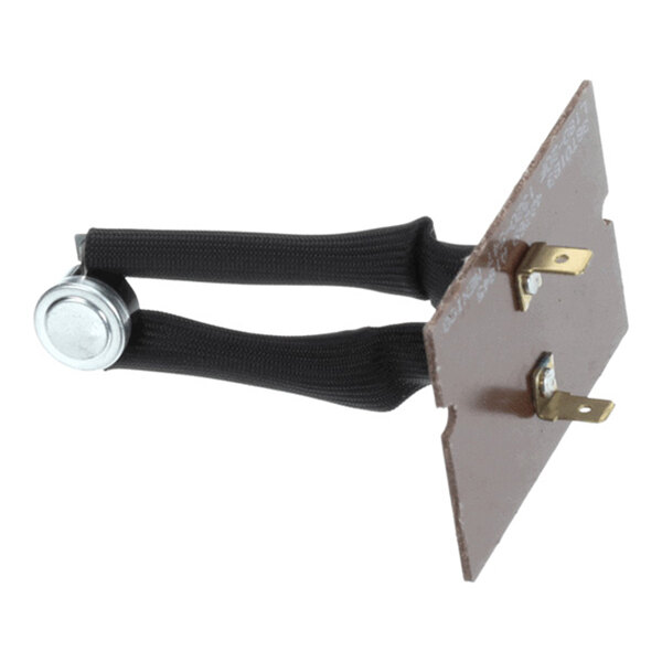 A small electronic component with two black insulated wires connected to a metal disc and a brown rectangular mounting plate with two metal terminals.
