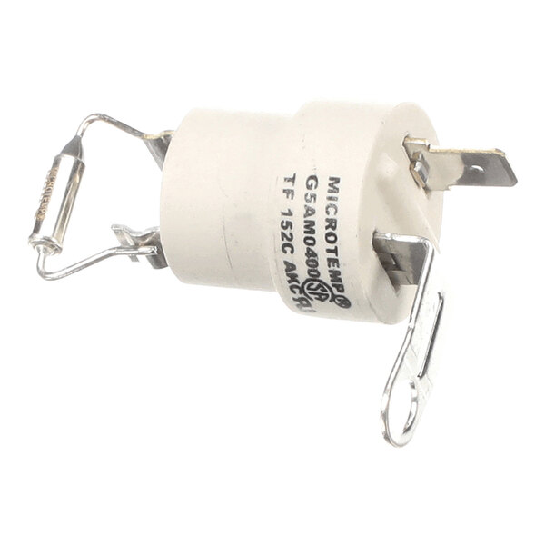 A cylindrical white component with metal terminals and attached wires, featuring printed text and a small fuse visible on one side.