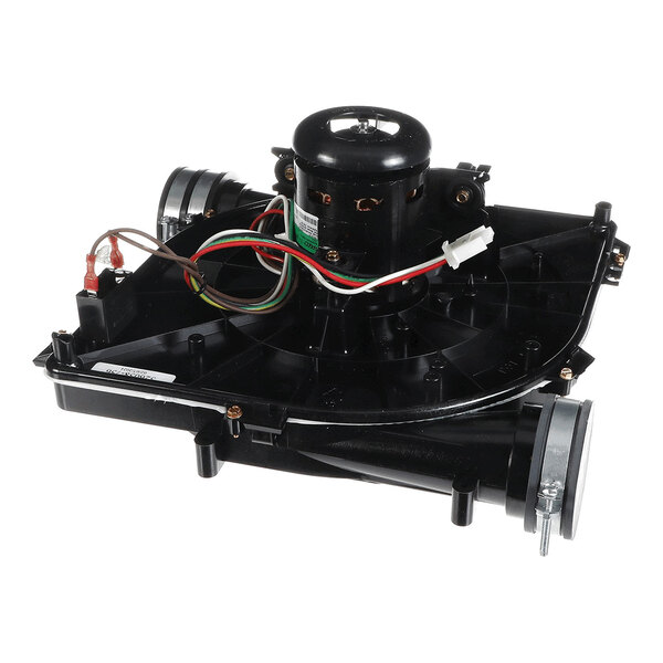 A black mechanical assembly with a central motor, wiring, and two cylindrical outlets, likely part of an HVAC or furnace system.