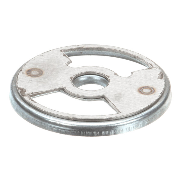 A round, metallic disc with a central hole and two large cut-out sections, likely part of a mechanical assembly.