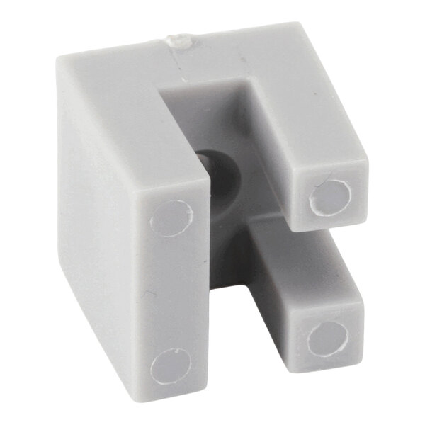A gray, U-shaped plastic clip with four circular indents on the ends and a central hole, viewed from an angle.