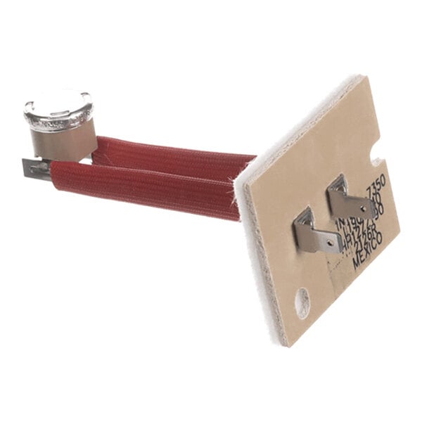 A rectangular component with two metal prongs, two red insulated wires, and a small cylindrical metal part attached to one end.