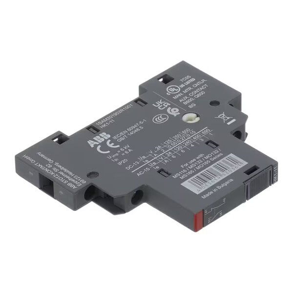 A flat, rectangular, dark gray electrical component with multiple certification markings, technical specifications, and a barcode label on its surface.