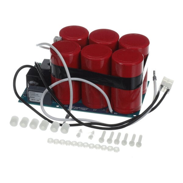 A circuit board assembly with six large red cylindrical components, several wires, and a set of white plastic connectors and fasteners arranged in front.