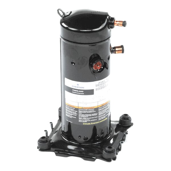 A black cylindrical mechanical component with copper pipe fittings and a label, mounted on a metal base.