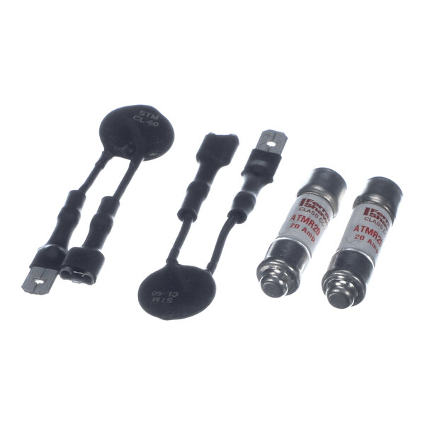 Two pairs of electronic components are shown: the left pair consists of black disc-shaped thermistors with attached wires, and the right pair consists of cylindrical fuses with metal ends and labeled white bodies.