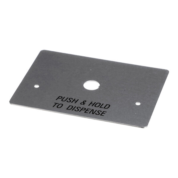 A rectangular metal plate with three holes and the text 'PUSH & HOLD TO DISPENSE' engraved on it.