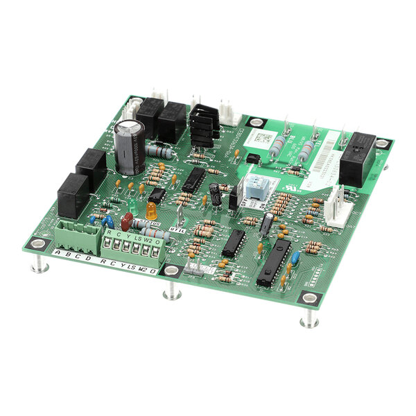 A green electronic circuit board with various components such as capacitors, resistors, relays, and connectors mounted on it.
