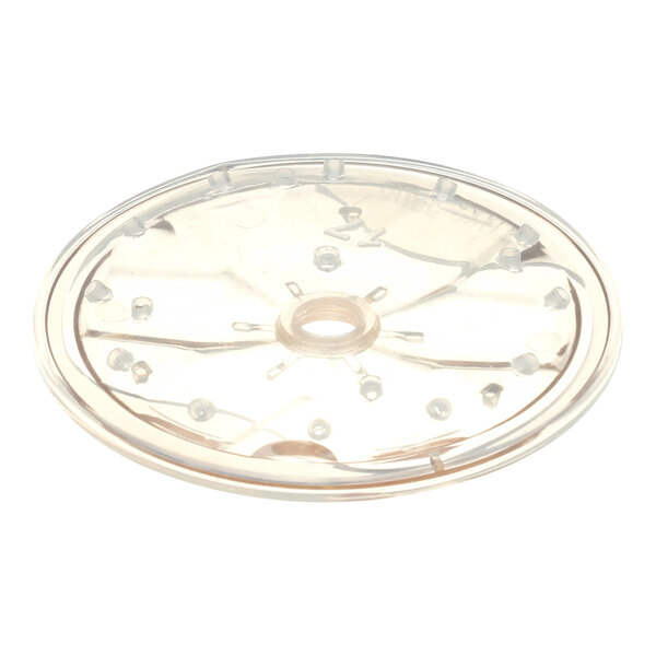 A transparent, round plastic disc with a central hole and multiple small protrusions arranged in a circular pattern.