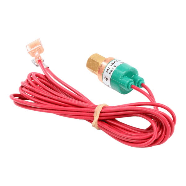 A coiled red wire attached to a green and brass cylindrical component with a connector at one end.