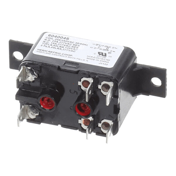 A black electrical relay with multiple metal terminals and a white label on top, mounted on a bracket with two screw holes.