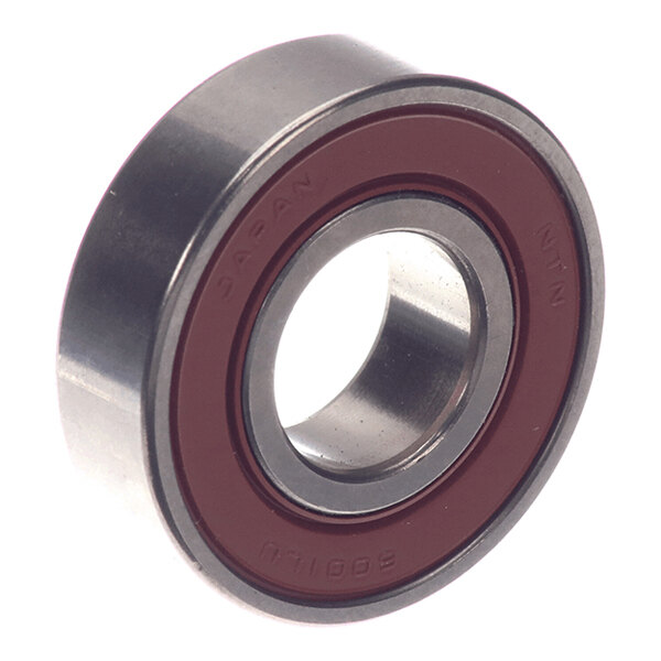 A metal bearing with a red seal on one side, featuring a central hole and cylindrical shape.