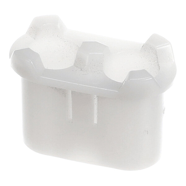 A small, white, plastic component with a rounded rectangular shape and notched edges on the top.