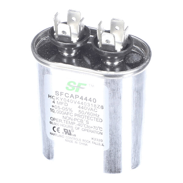 A metallic oval capacitor with two sets of electrical terminals on top and a label displaying technical specifications.