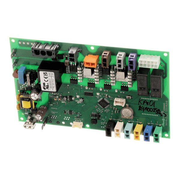 A green electronic circuit board with various connectors, relays, capacitors, and other electronic components mounted on it.