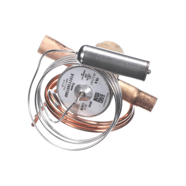 A metallic component with coiled tubing, a cylindrical chamber, and labeled circular plate, likely part of a mechanical or HVAC system.